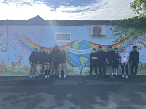 Ark Pioneer Pupils in front of mural